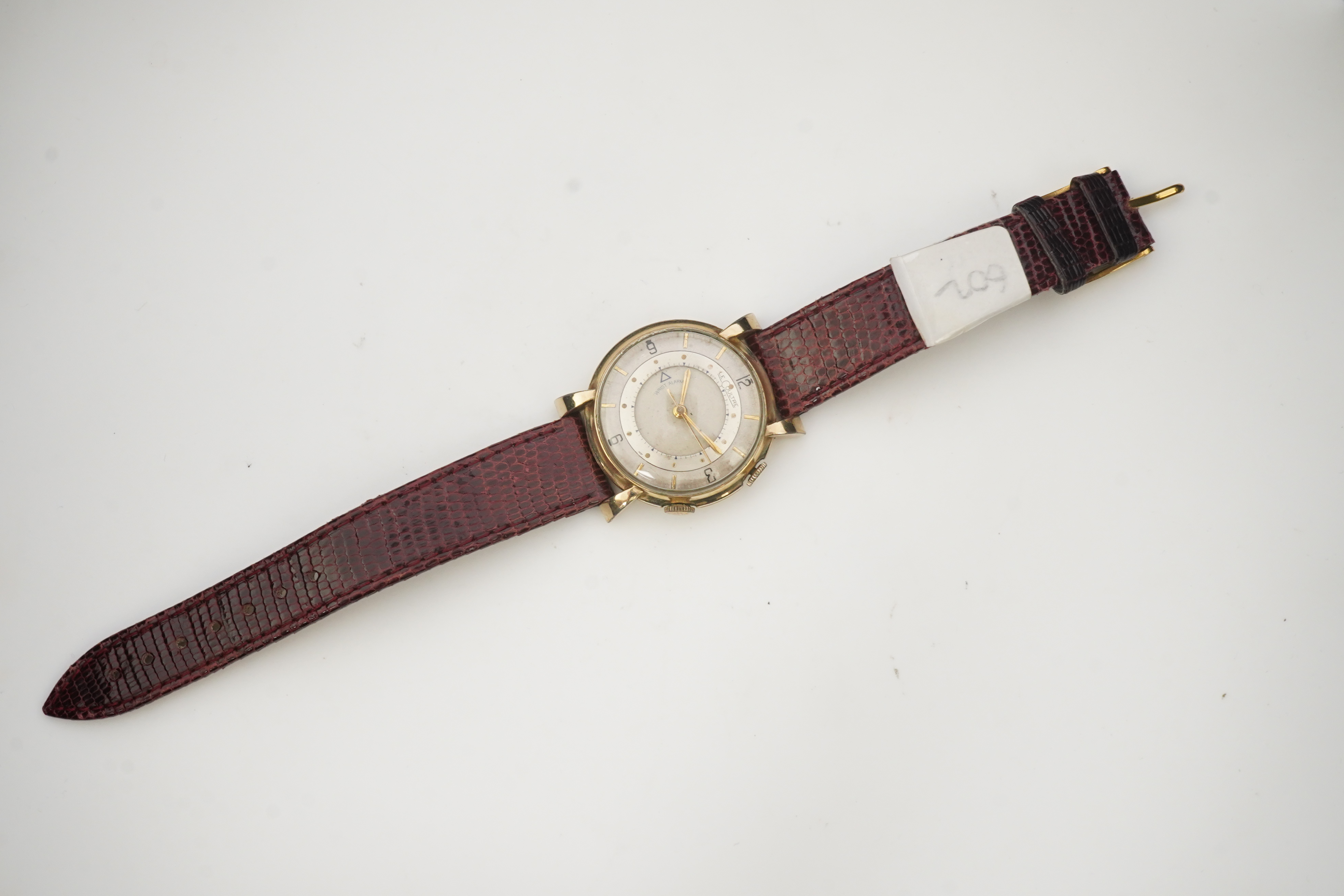 A gentleman's 1950's? 10k gold filled Jaeger LeCoultre Memovox manual wind wrist watch, on a later associated leather strap